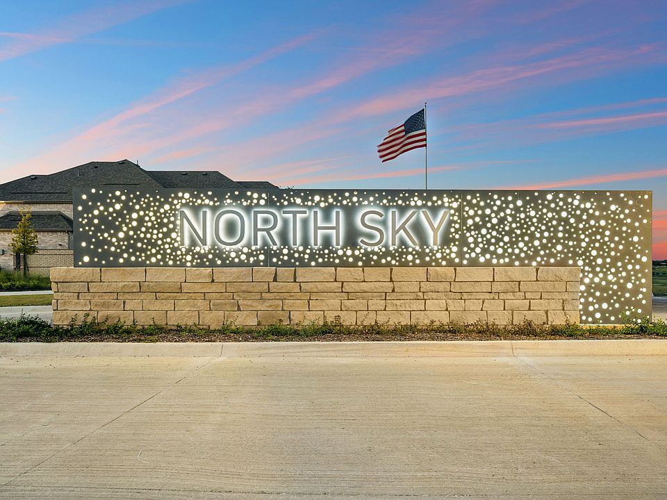 North Sky community entry sign lit up at night