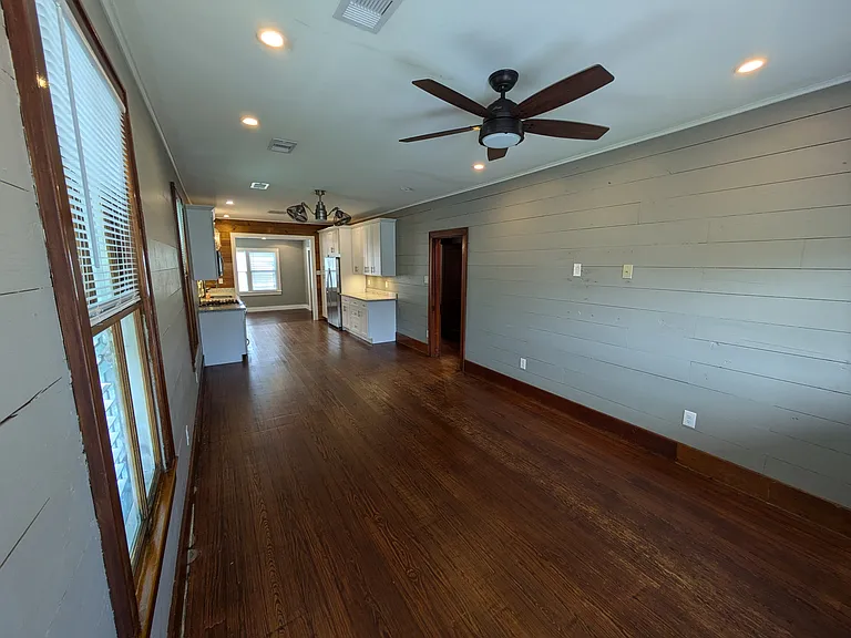 Large living room & dining room area with original shiplap walls. Ample electrical outlets and wall mount TV hook ups - no unsightly wires.