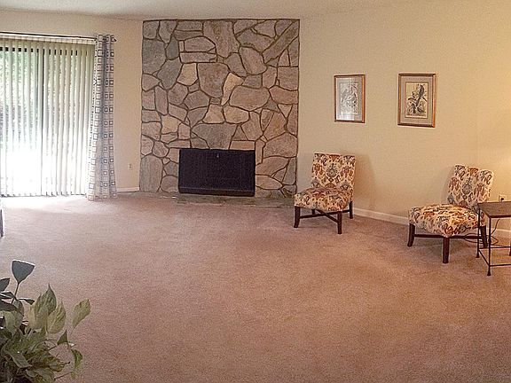 Large living room with fireplace and patio