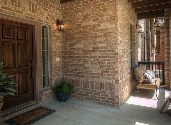 Inviting Entry Boasts Impressive Brick Work and Rustic Beams