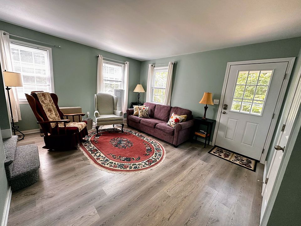Living room includes German engineered couch, new floors, 2 rocking chairs, newly painted, and 50 inch TV