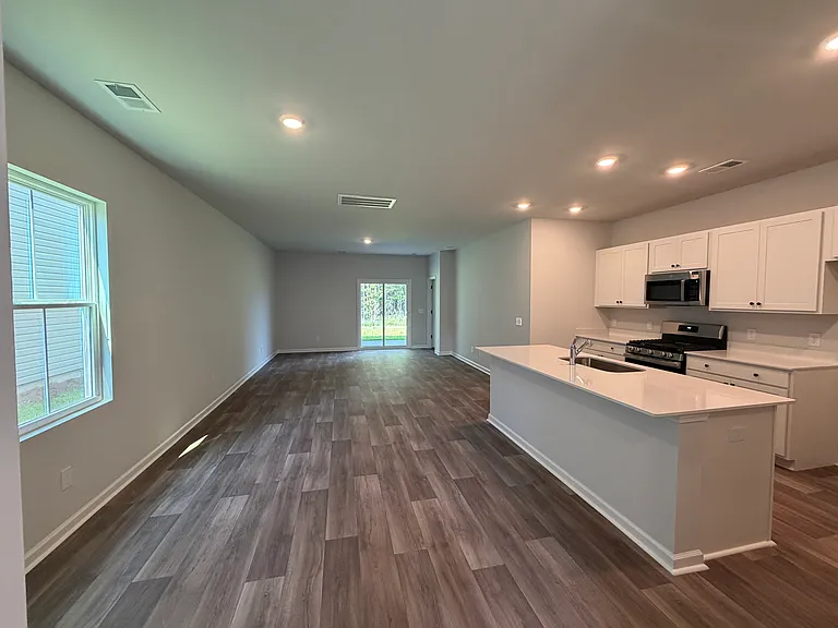 Open concept kitchen, dining area a living room