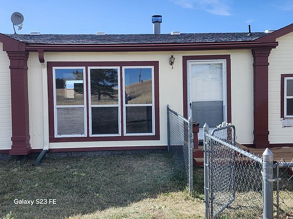 Front of home showing gate access to fenced yard.