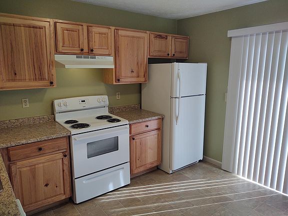 Kitchen showing slider door with blinds.