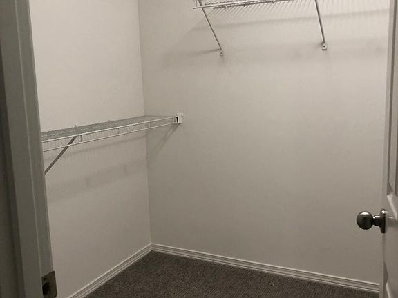 Walk in closet in master bedroom. Photo doesn't show the added racks and pull out shelving