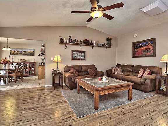 The living room offers a wall of windows to the rear yard and is open to a bayed