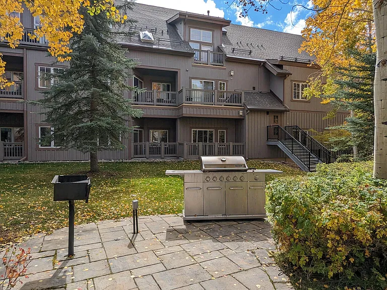 Gas and charcoal grills available for your enjoyment, surrounded by a variety of patio furniture.