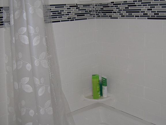 Remodeled bathroom with large soaking tub; separate vanity. Toilet is dual flush Toto fixture - high quality, self-cleaning, yet water efficient.