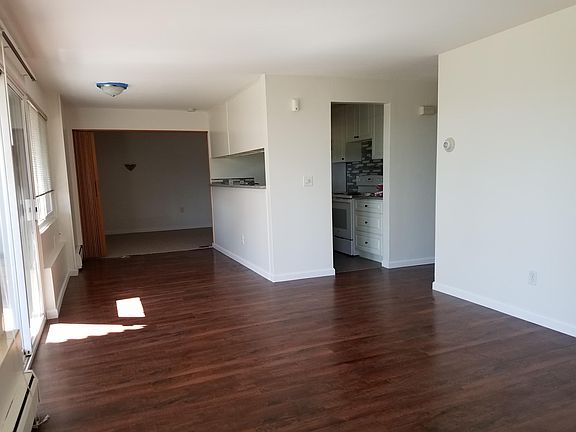 Dining area off of kitchen with large view window, den with