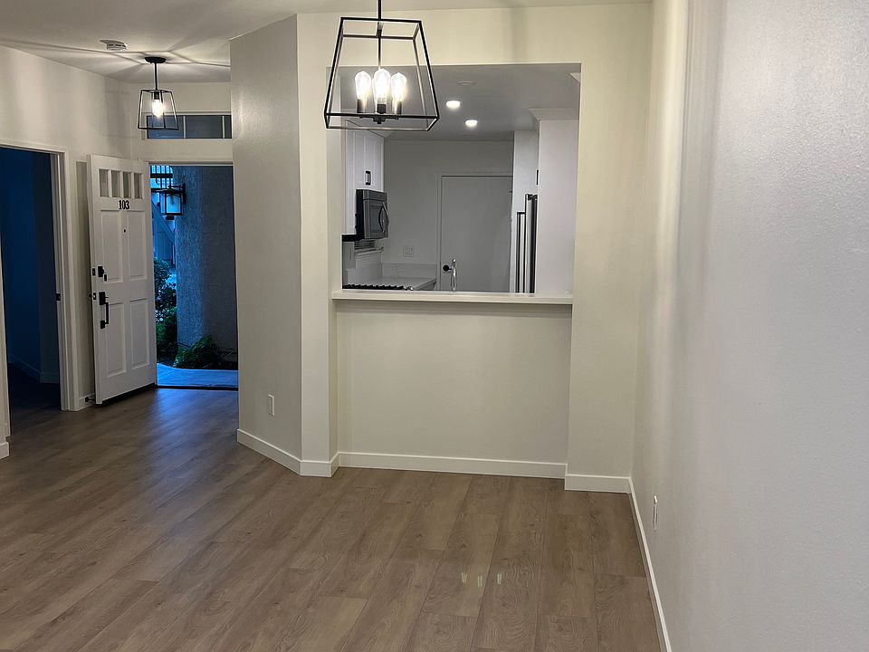 Standing in the living room viewing the kitchen, front door, 2nd bedroom.