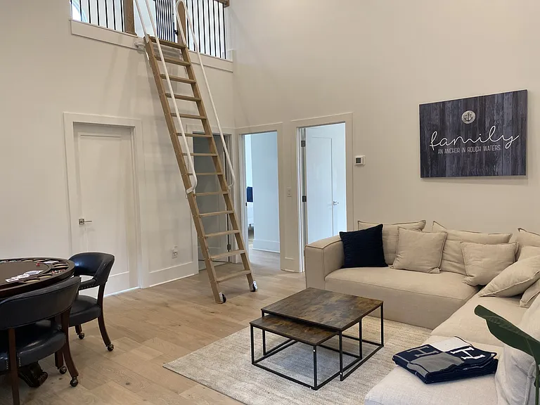 Family room with TV. This level has three bedrooms, two bath and a loft.