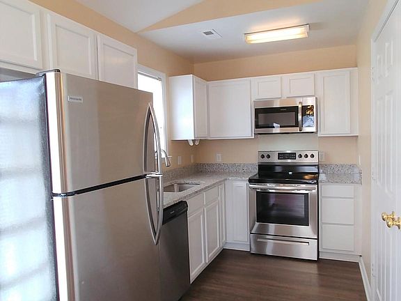 Beautifully updated kitchen w vaulted ceiling, granite countertops, stainless steel appliances and white cabinets