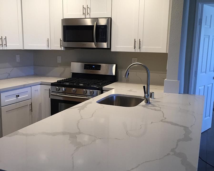 Newly renovated kitchen with quartz counter tops and peninsu