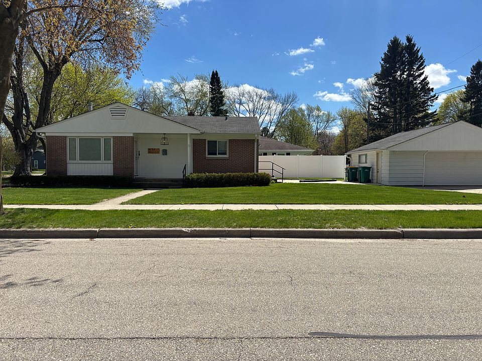 Front of home with patio and two car garage