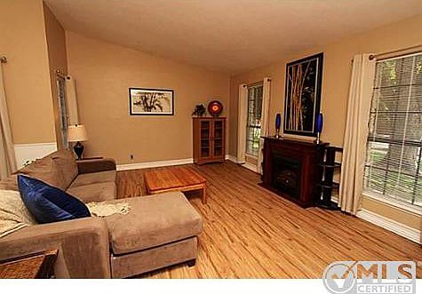 Spacious living room has vaulted ceiling and lots of natural lig