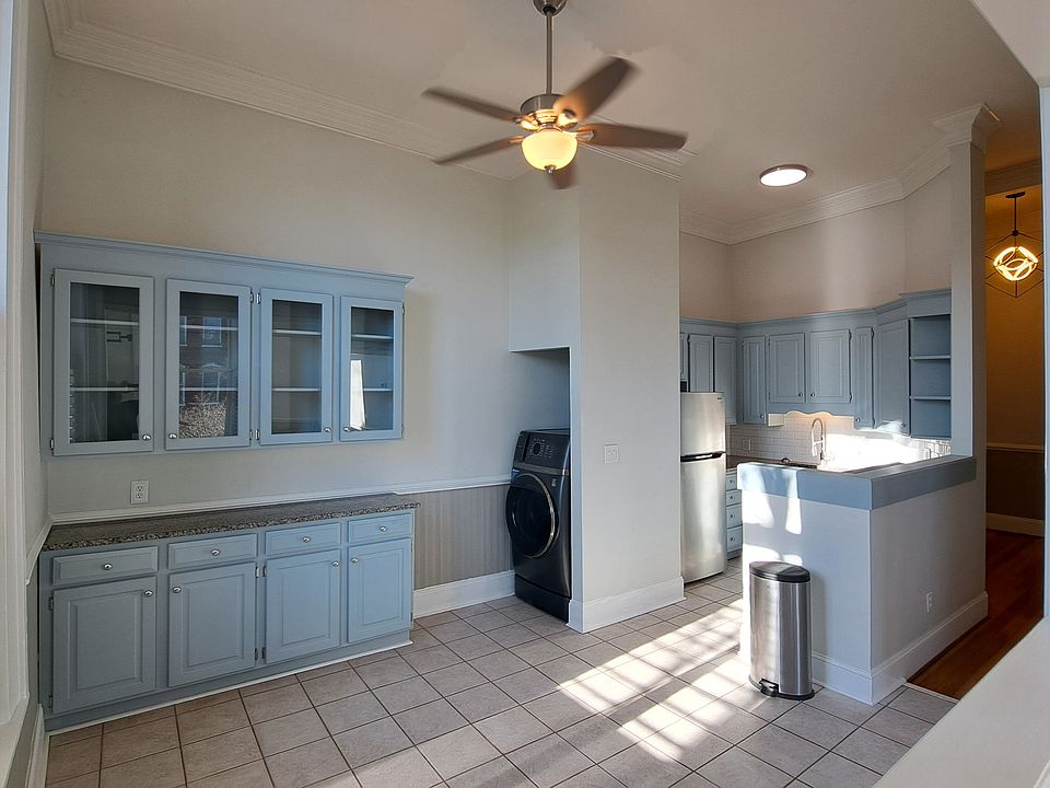 Dining area, kitchen, and combo washer/dryer unit.