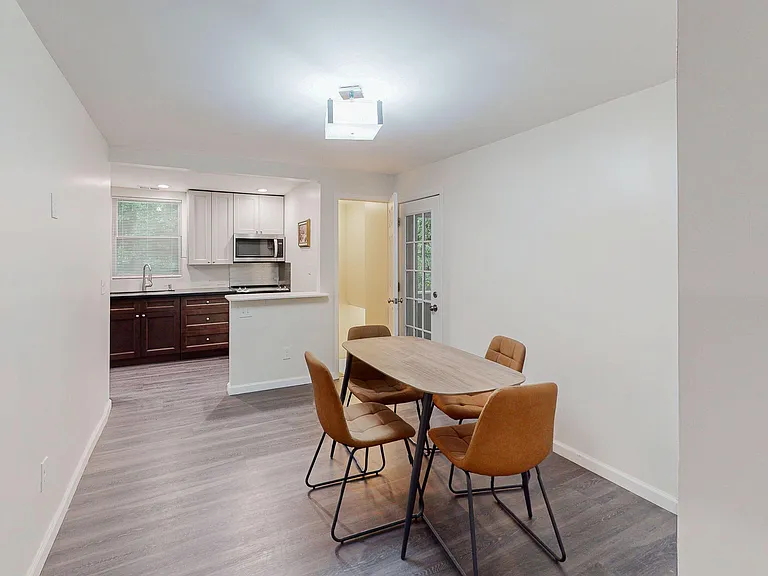 Dedicated dining area with room for a full table, open to the kitchen with breakfast bar seating and easy flow to the patio d