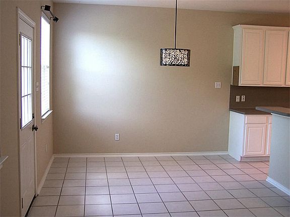 Dining area has tile floors and is open to den.