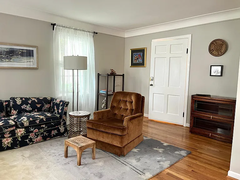 Living room with apartment door in center.