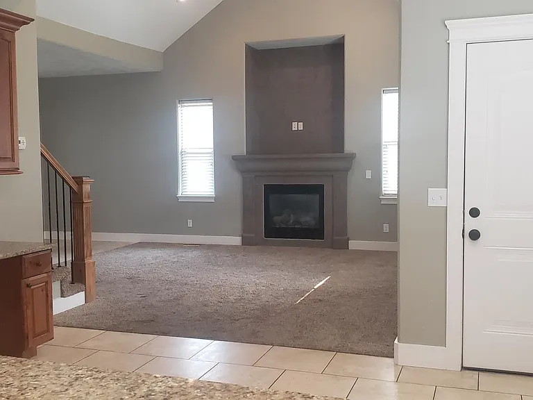 Vaulted ceilings and gas fireplace in living room.