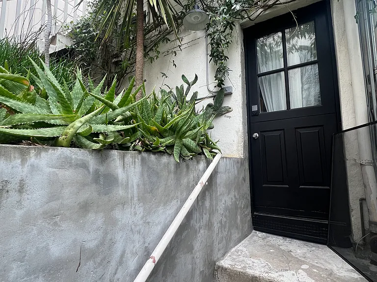 front entrance, detached studio with view above.