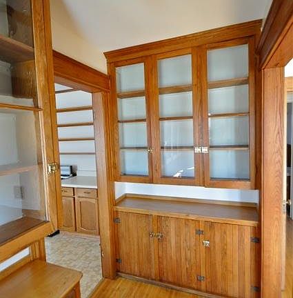 Glass doors and chestnut wainscoting highlight the pantry.