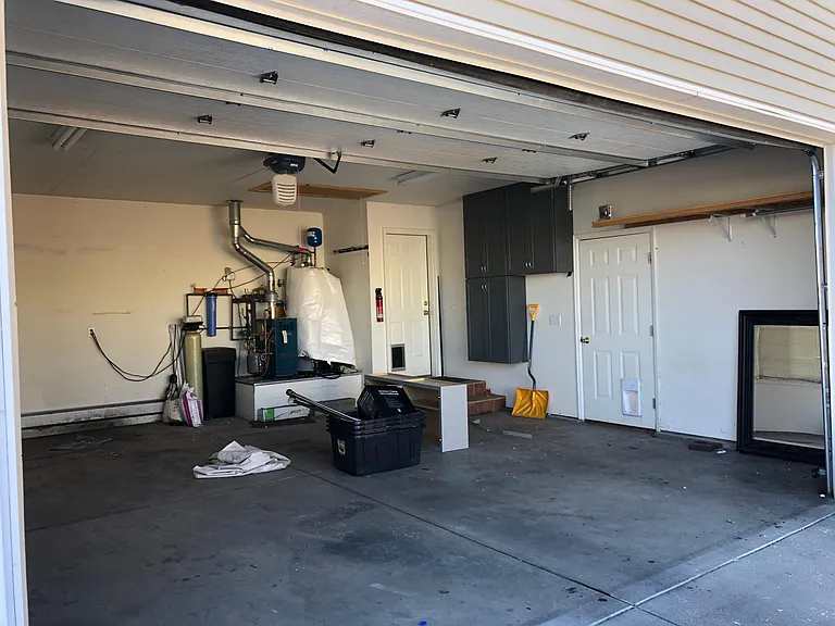 Over-sized garage. Cabinets and shelving included. Pull-down attic stairs. All else, not included.