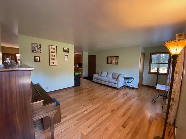 Standing at entrance viewing living room with kitchen entrance dining room entrance and door to basement and garage