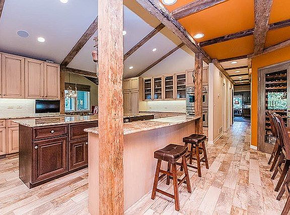 Open gourmet kitchen with 2 islands perfect for a party or a quiet dinner for 2. Barn wood columns and coffered ceilings add to the modern rustic details.