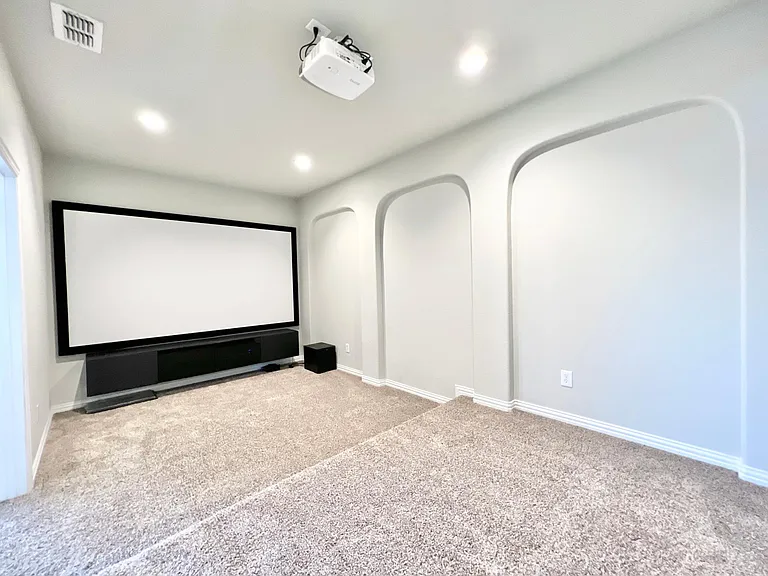 Media room with screen, speaker system and projector