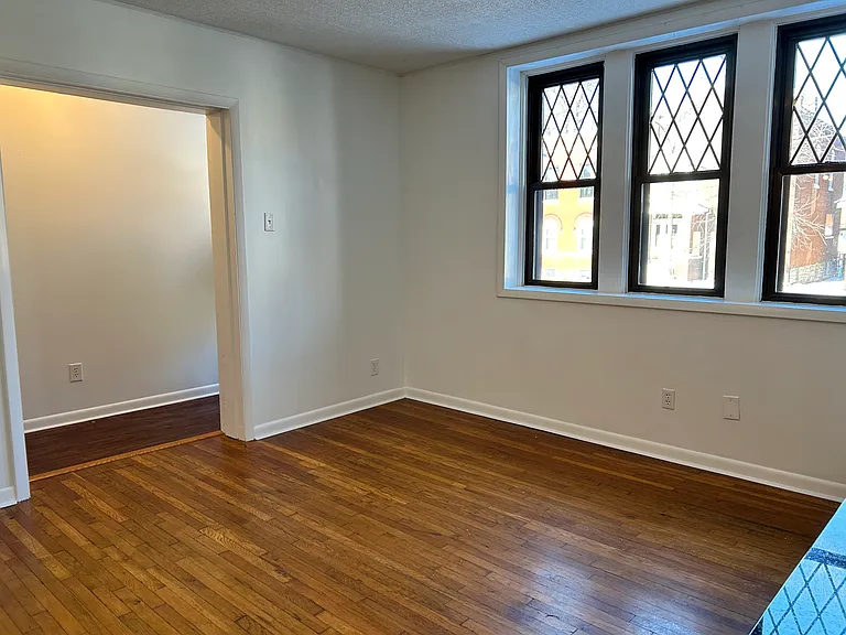 Living room sits past the cased opening off the front entrance/main hallway