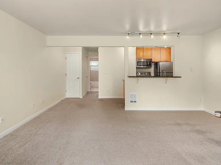 Looking into dining area and down hall from entry.
