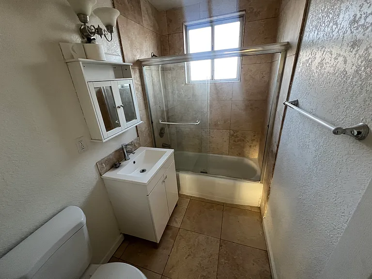 Travertine stone floor shower bathroom clear glass enclosure