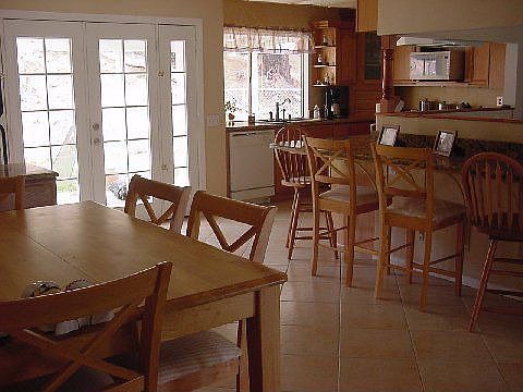 dining room with eat at bar and pass through to living room