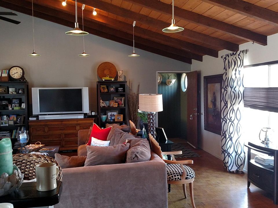 From north side facing south - entry door and west-facing windows. No real ocean view but you can hear and smell the ocean roaring! Vaulted ceiling is 2 stories high on east side.