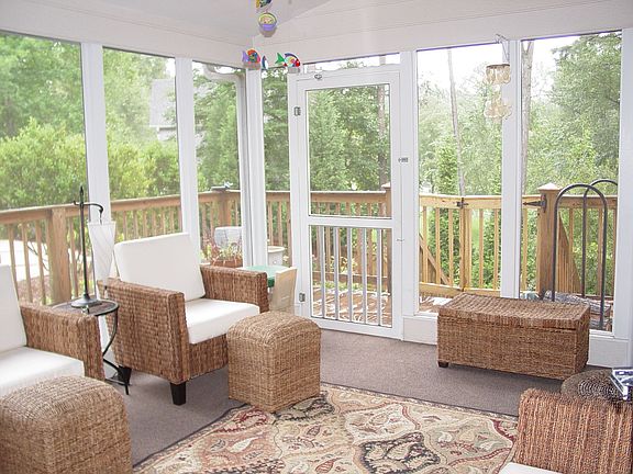 Lovely sunroom overlooking serene pool setting