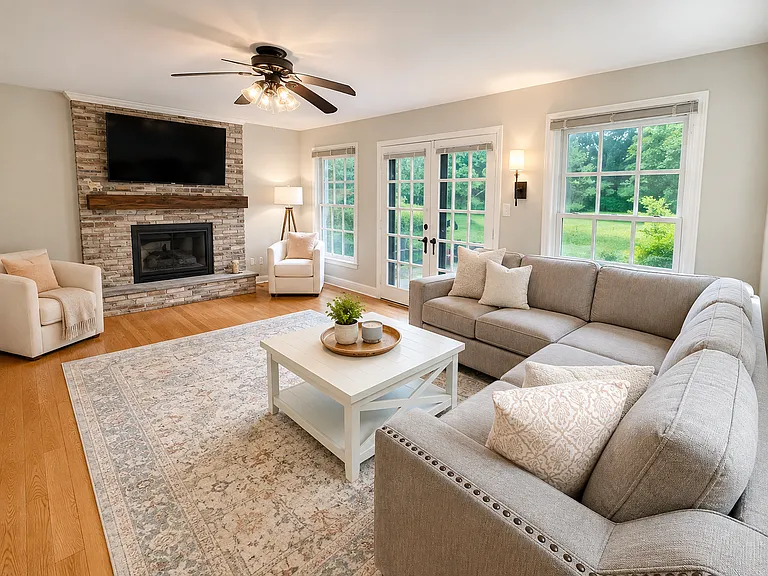 Family Room with wood burning fireplace and double door access to Patio