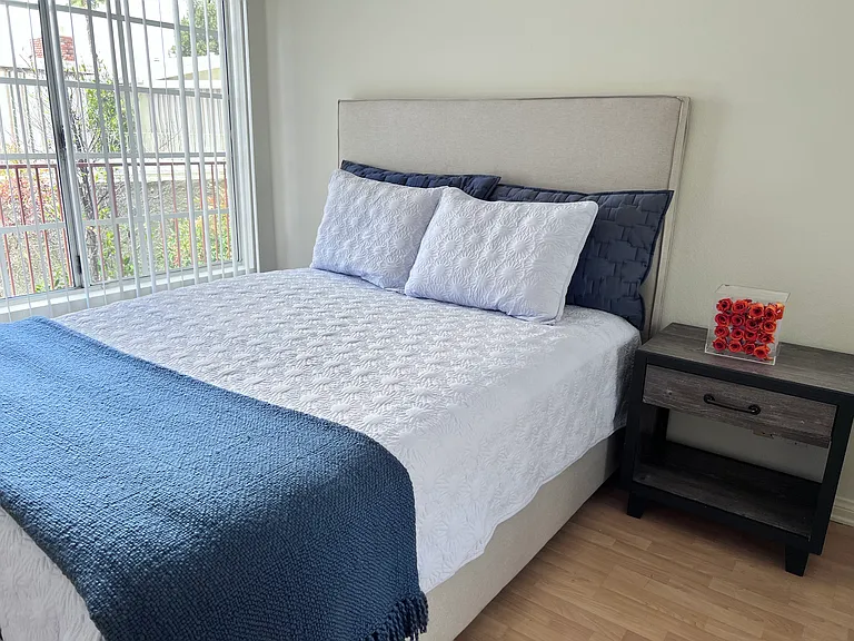 Second Bedroom with sliding door and mirrored closet. Third bedroom has same size may be used as bedroom or office.