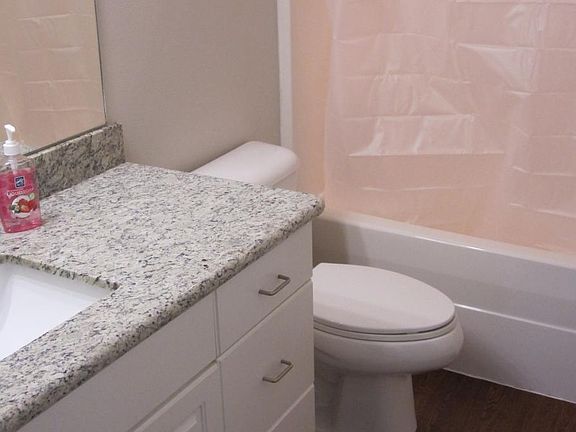 Secondary Bathroom with granite countertops