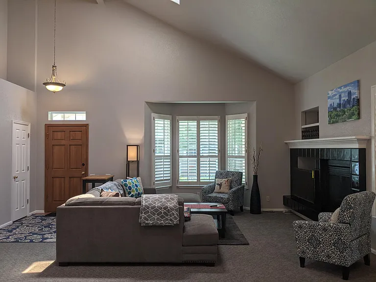 Spacious living room, with bay window and plantation shutters throughout the home!