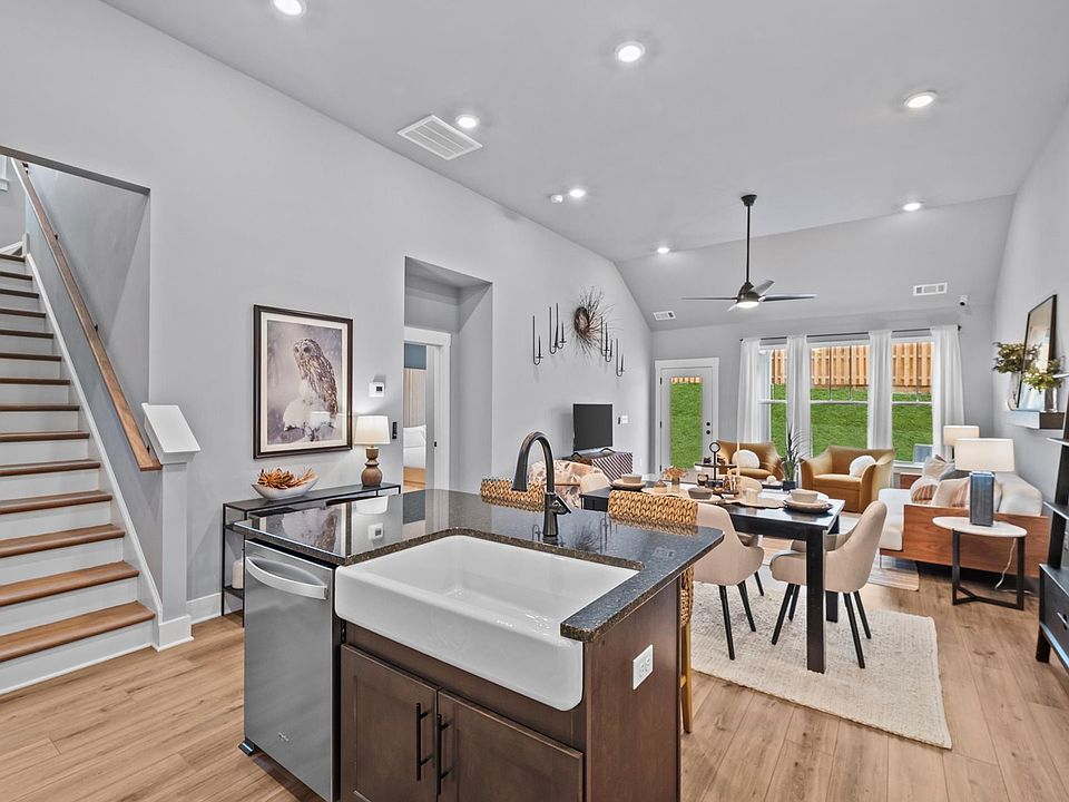Kitchen with large island with quartz countertops, white cabinetry, Whirpool appliances at Aspen Rid