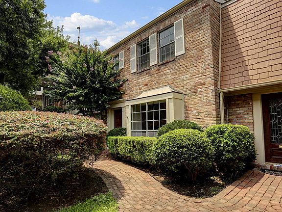 The town house the brick elevation, with the bay window looking out to a beautifully manicured court
