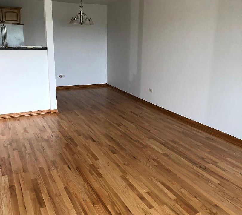 Gorgeous refinished hardwood floors. Living room with eat in kitchen.