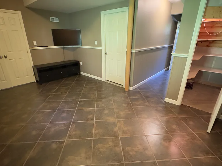 Ground level family room with under stair storage and access to laundry room.