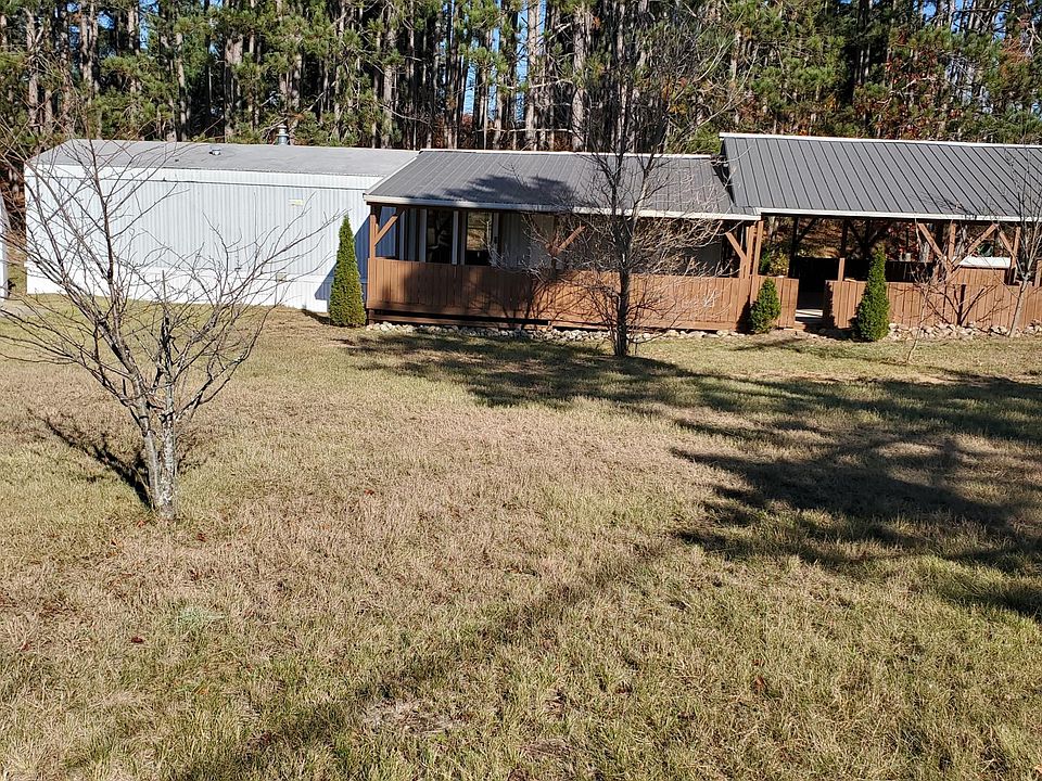 Large front yard, with some small trees.