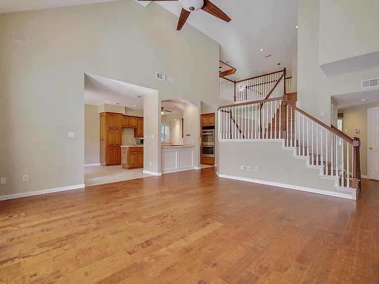 Soaring ceilings, wood flooring, built-ins, fireplace and an abundance of light define this expansive living space