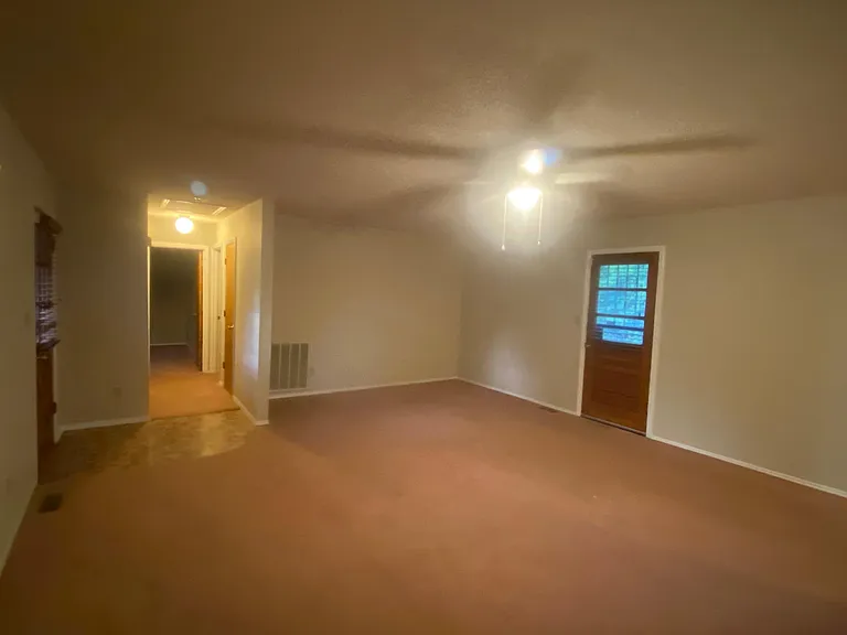 Living Room showing Rear Door and Hallway to Bedrooms 2 and 3