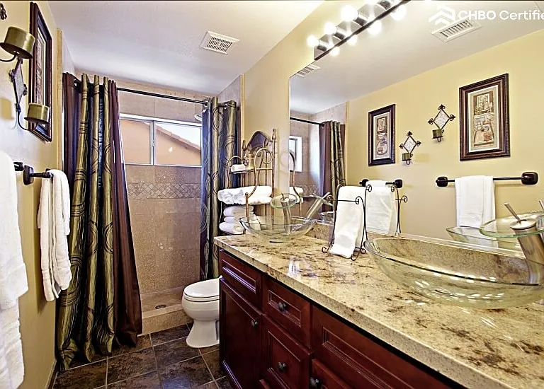 Second full bath with dark tile flooring