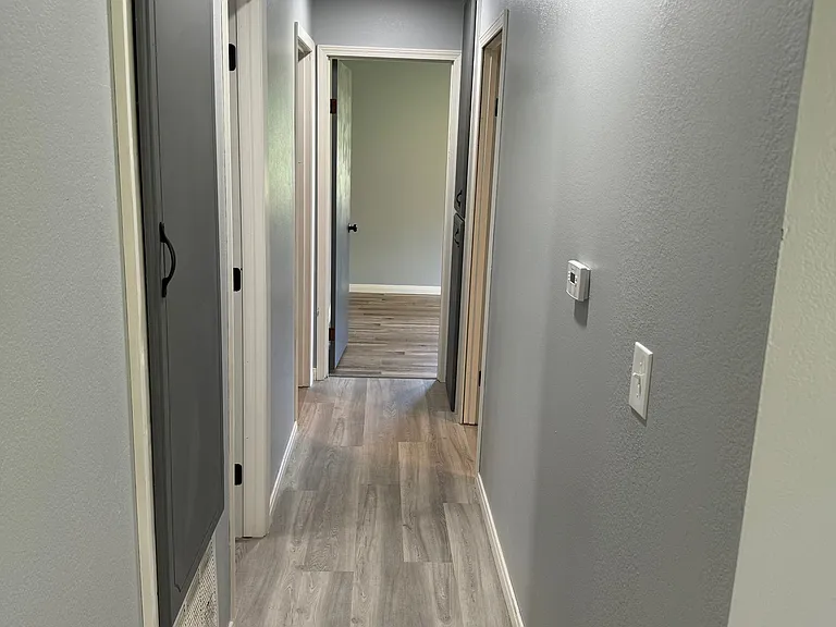 Hallway to bathroom and 3 other bedrooms