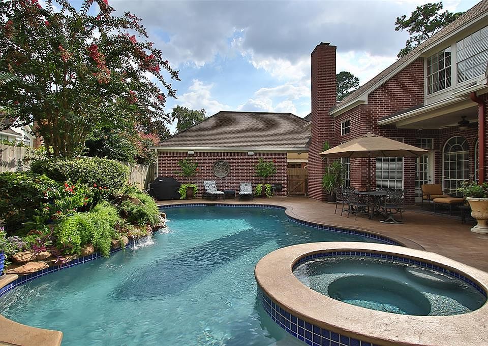 This backyard is a true oasis. Gorgeous landscaping and waterfall make this a true paradise
